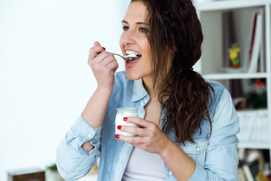 woman eating full fat yogurt